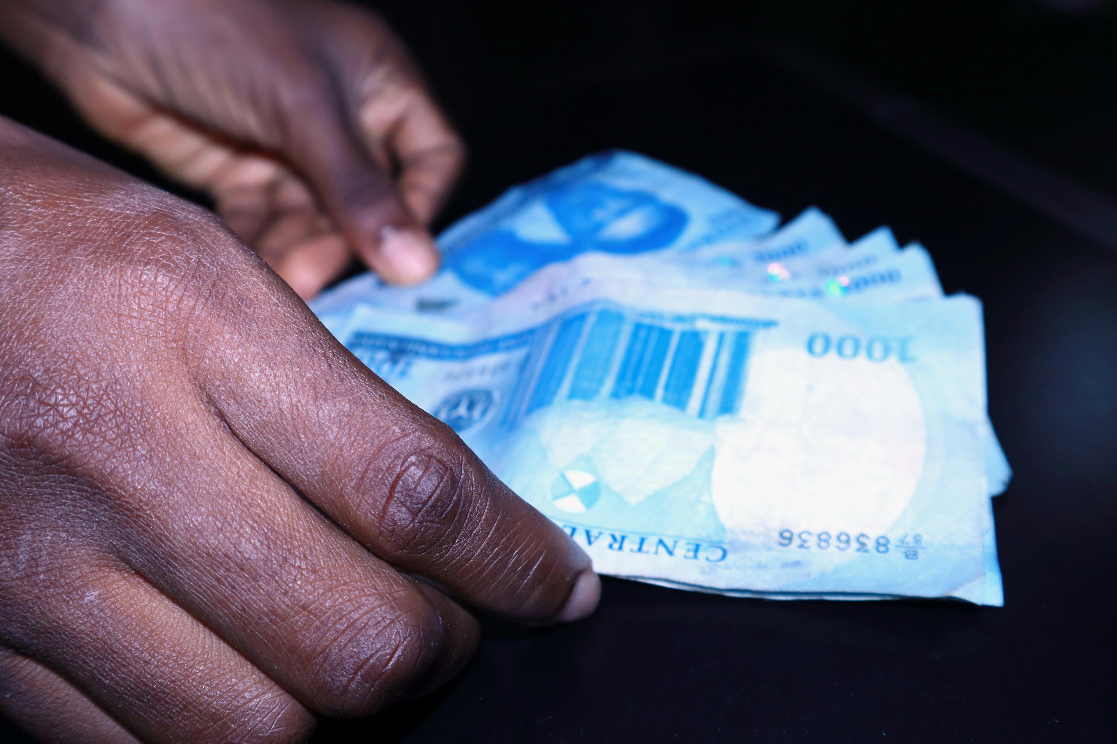 Hands exchanging cash in an envelope